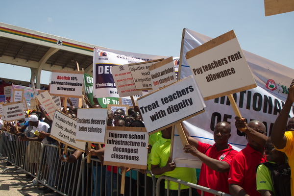 A section of teachers at the 2022 celebration of May Day bearing placards of some of their demands A section of teachers at the 2022 celebration of May Day bearing placards of some of their demands